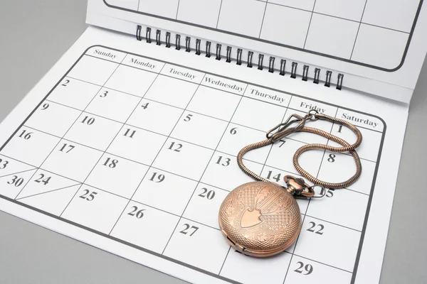 Taschenuhr im Kalender — Stockfoto