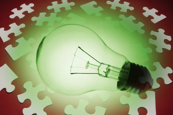 Light Bulb and Jigsaw Puzzle Pieces — Stock Photo, Image