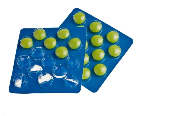 Зеленые таблетки в голубой упаковке . — стоковое фото