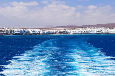 Water trail of a ferry boat. clipart