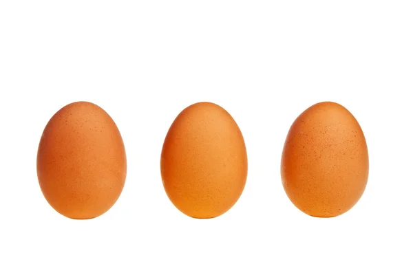 Três ovos castanhos . Imagens Royalty-Free