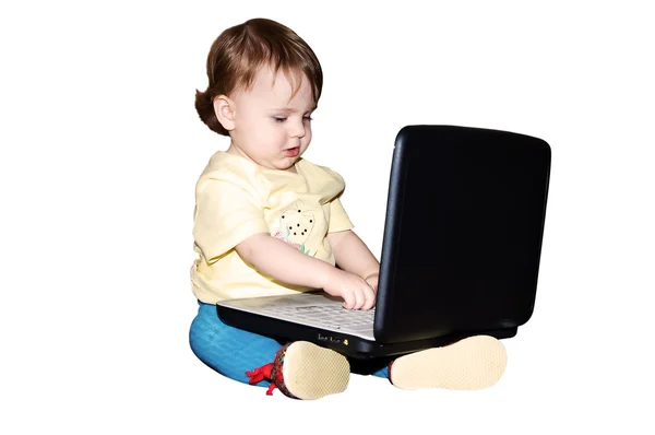 stock image The child plays with the laptop