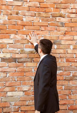 Businessman by brick wall clipart