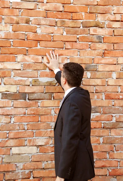 stock image Businessman by brick wall