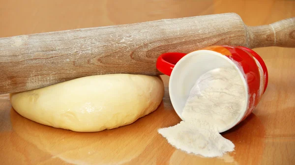Rolling pin over dough — Stock Photo, Image