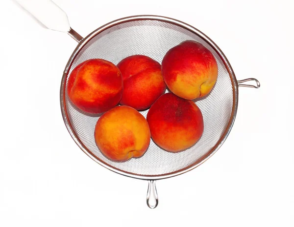 Peaches in colander isolated — Stock Photo, Image