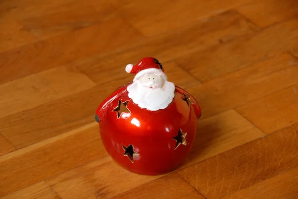 Christmas candlestick on parquet floor — Stock Photo, Image