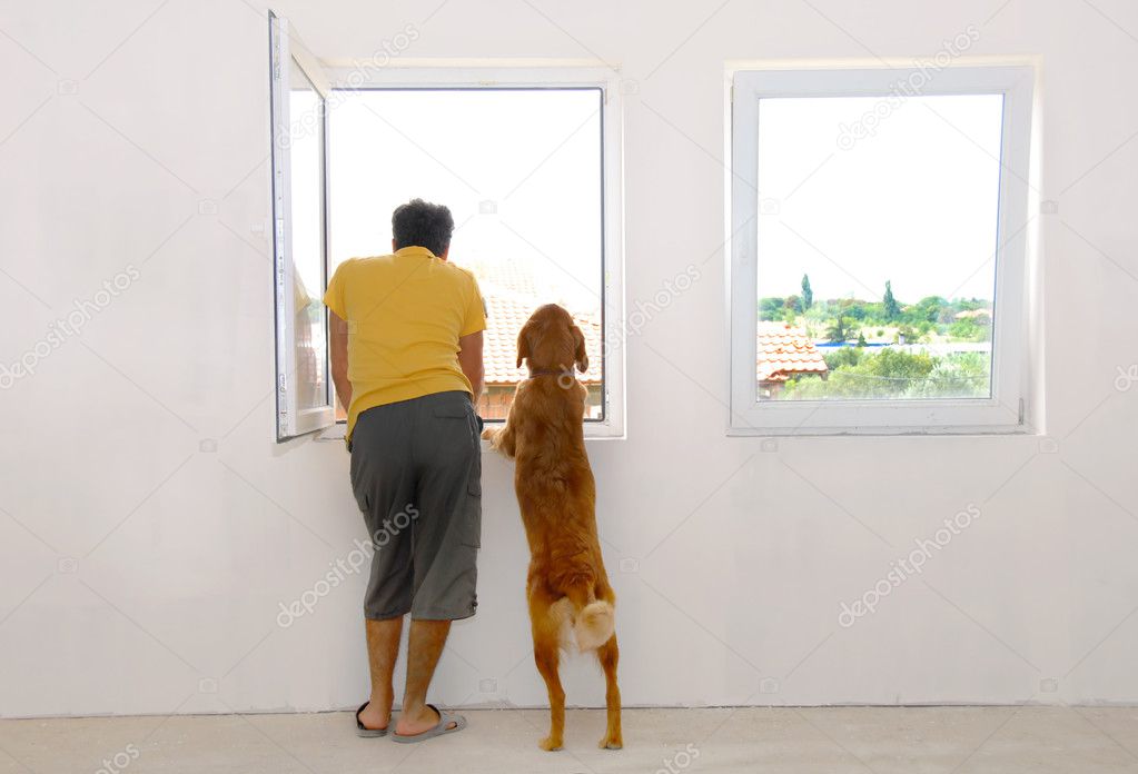 Man and dog looking through window