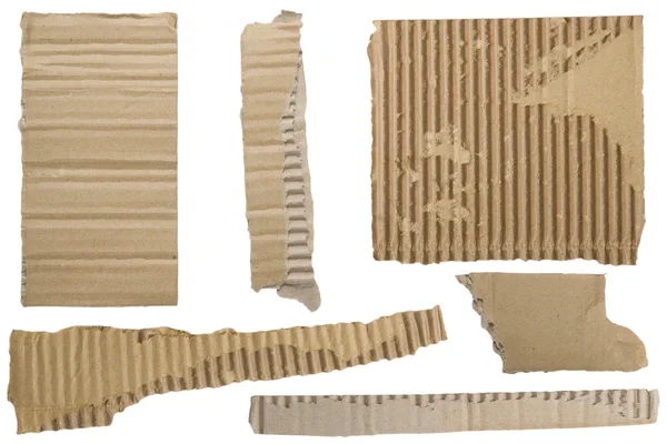 Pieces of torn brown corrugated cardboard — Stock Photo, Image