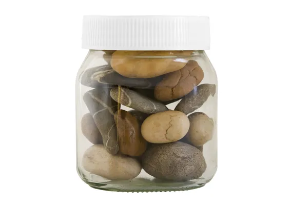 Transparent jar with different stones — Stock Photo, Image