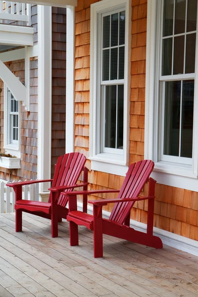 Two red Adirondack chairs