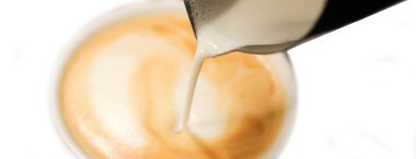 Pouring milk from a jug into a cup of coffee clipart