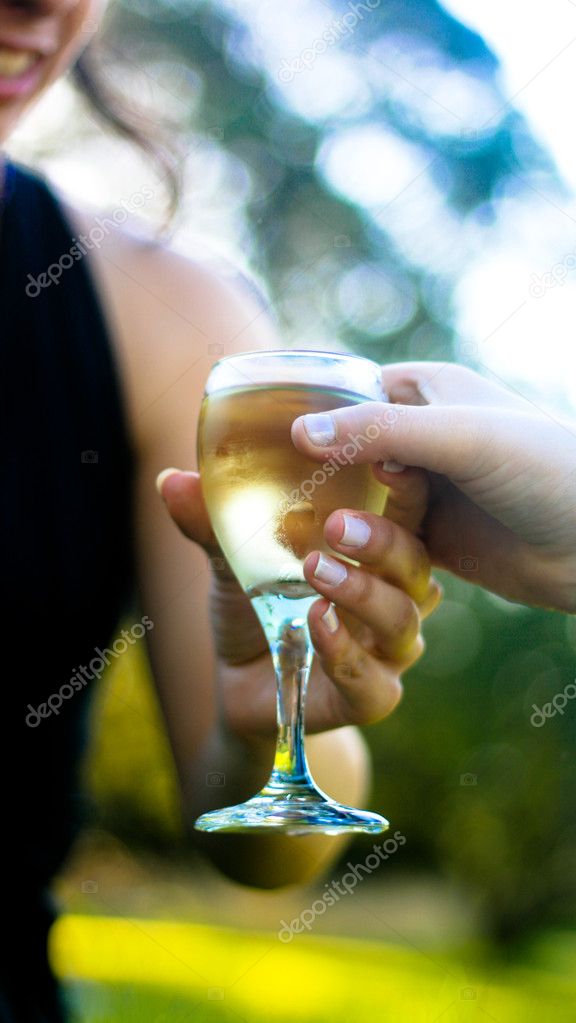 Woman hand holding a glass of  white wine