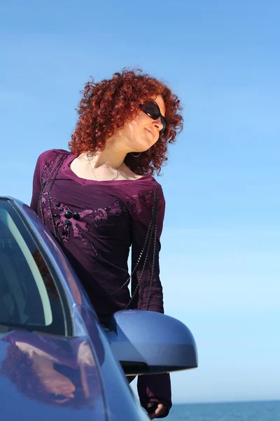Красная девушка в машине — стоковое фото