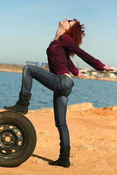 stock image The girl with a wheel at the sea