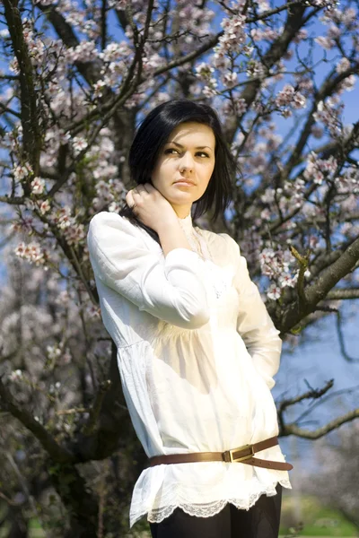 The beautiful girl near a blossoming tre — Stock Photo, Image