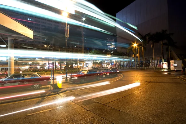 stock image Bus speeding through night street.