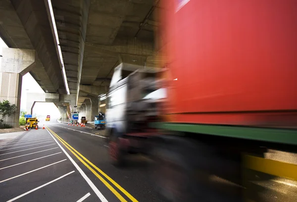 Highway under the bridge and container car moving — Stock Photo, Image