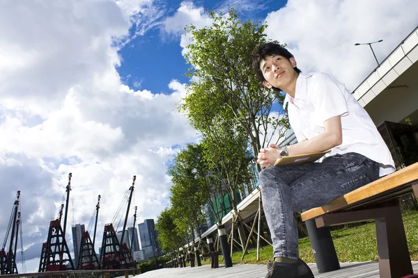 Asia man relax in the park — Stock Photo, Image