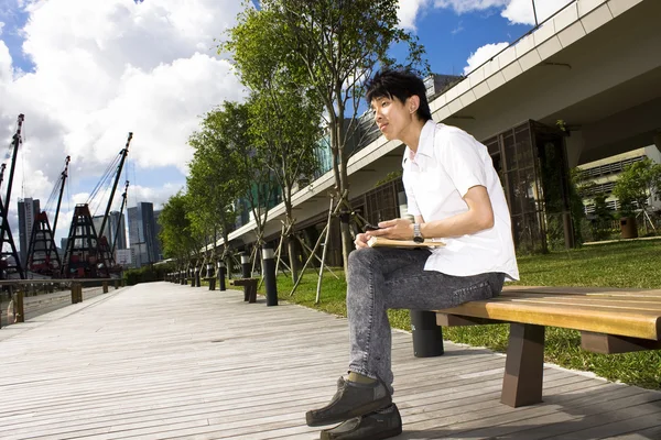 Asia man relax in the park — Stock Photo, Image