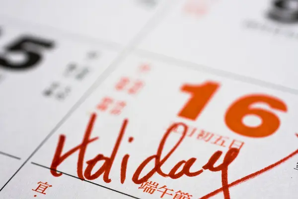Hand schrijven vakantie op kalender — Stockfoto