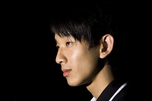 Portrét asijského muže v temnotě — Stock fotografie