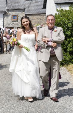 Bride and her Father walking up to the Church clipart