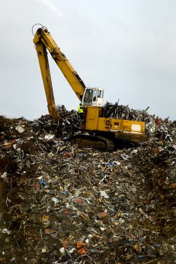 Bulldozwer working on a waste disposal clipart