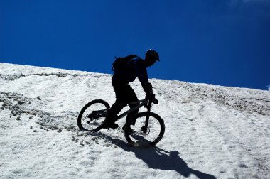 Sky, snow and mountain biker clipart