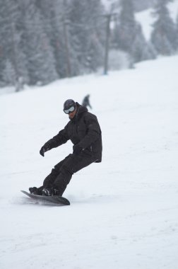 Snowboarder in snowfall clipart