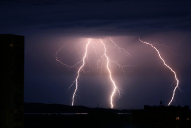 Lightnings over city clipart