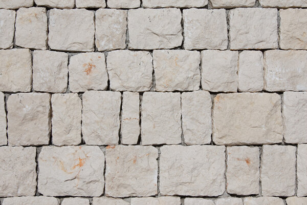 White wall made of stone blocks