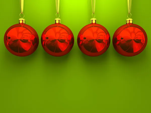 Yeşil zemin üzerine kırmızı Noel topları — Stok fotoğraf