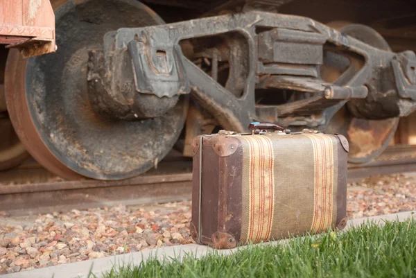 Maleta antigua y ruedas de tren — Foto de Stock