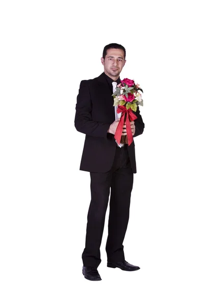 Affärsman höll blommor i handen — Stockfoto