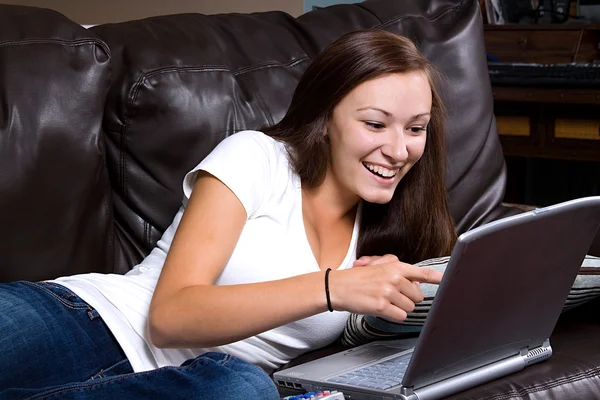 Sonriente adolescente mirando el ordenador — Foto de Stock