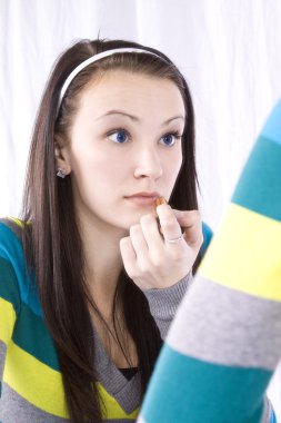 Teenager Putting on Make Up clipart