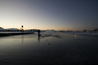 Fisherman Pulling his Sled on Ice clipart