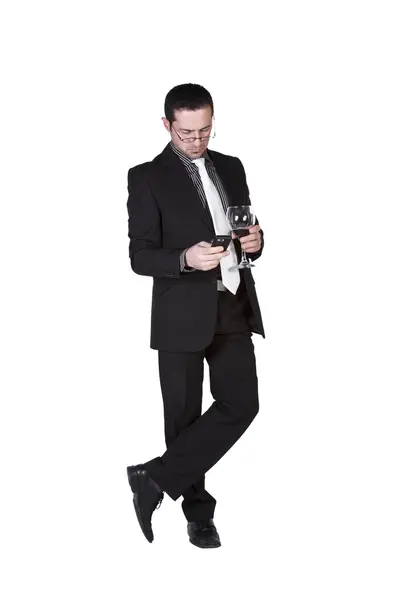 Empresario con un vaso de bebida mensajes de texto — Foto de Stock