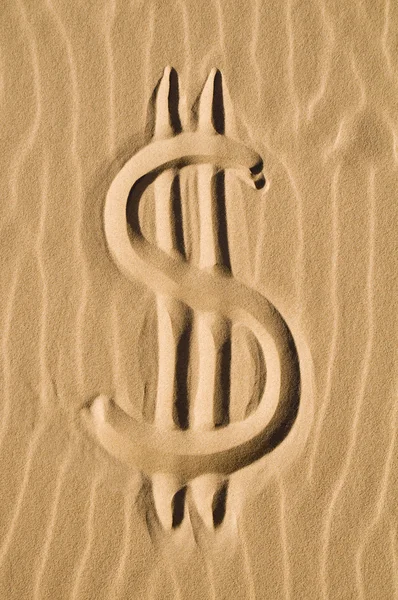 Signo de dólar en la arena — Foto de Stock