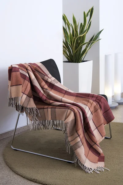 Plaid draped over a chair — Stock Photo, Image