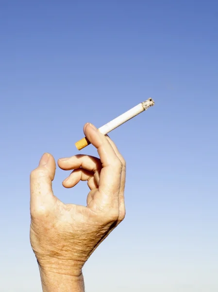 Holding a cigarette — Stock Photo, Image