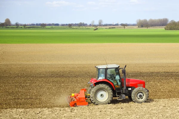 A tractor cultivating — Stock Photo, Image