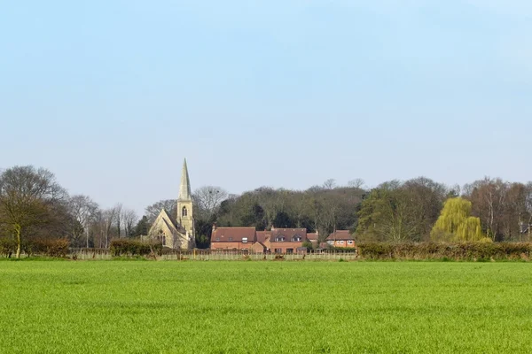 Wheatfield with rural church — Stock Photo, Image