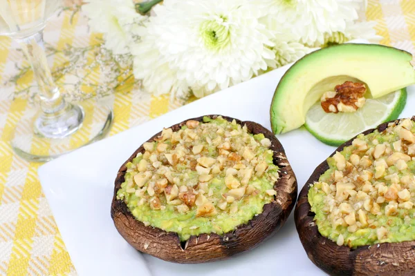 Avocado and walnut stuffed portabellas — Stock Photo, Image