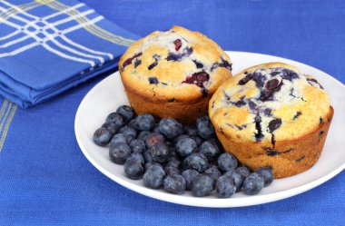 Delicious blueberry muffins and berries clipart
