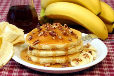 Pancakes with walnuts and bananas clipart