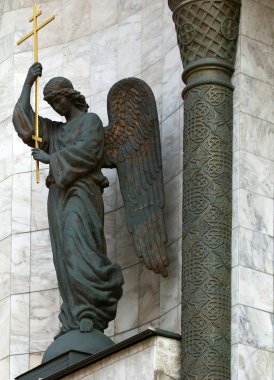 Sculpture of an angel with a cross clipart