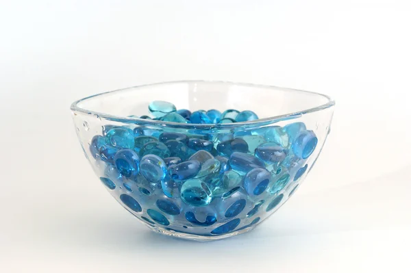 Brilliant blue stones from a glass — Stockfoto