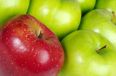 Red Apple in between Green Apples clipart